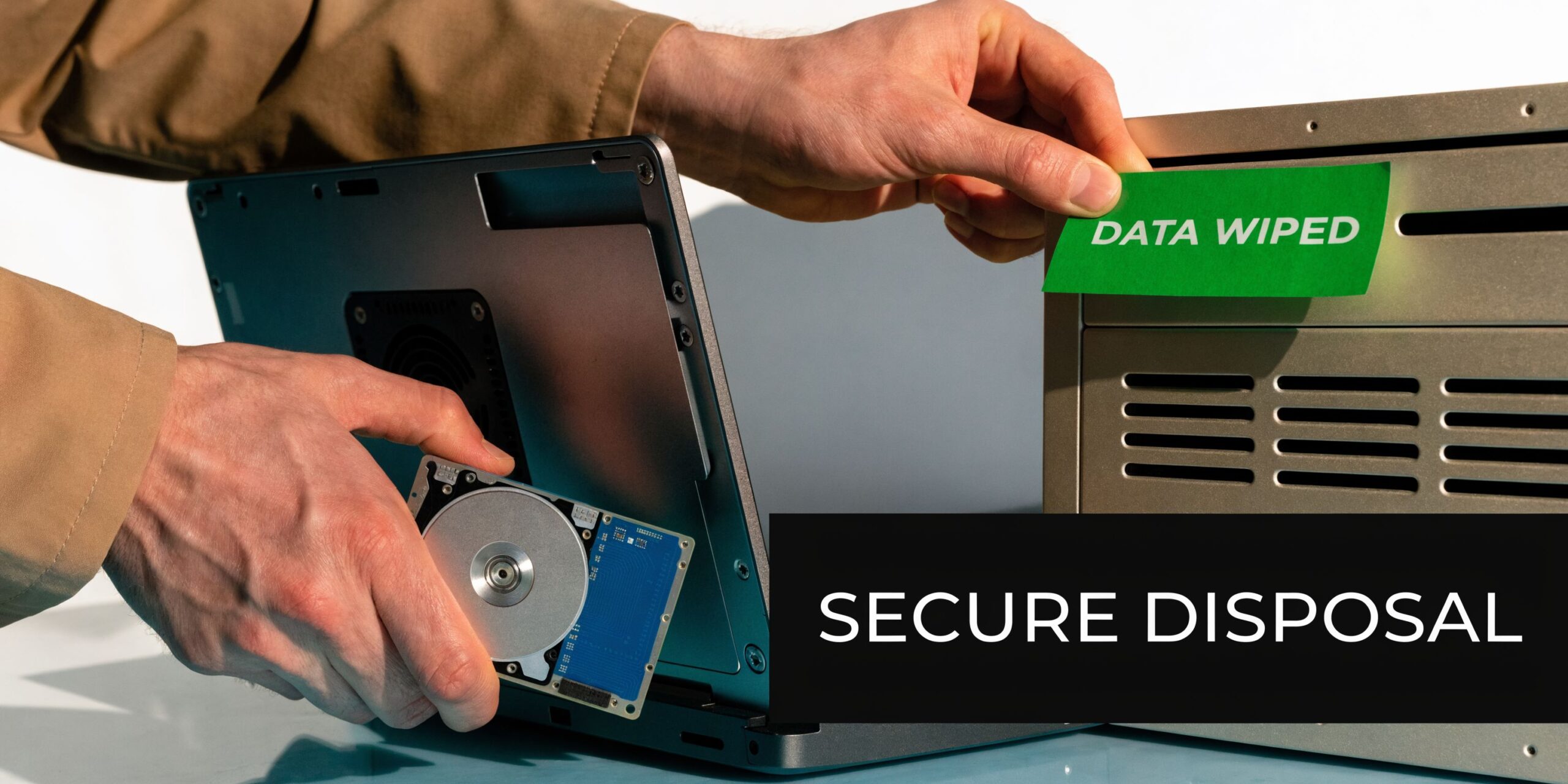 A person placing a Data Wiped label on a computer server after removing a hard drive.