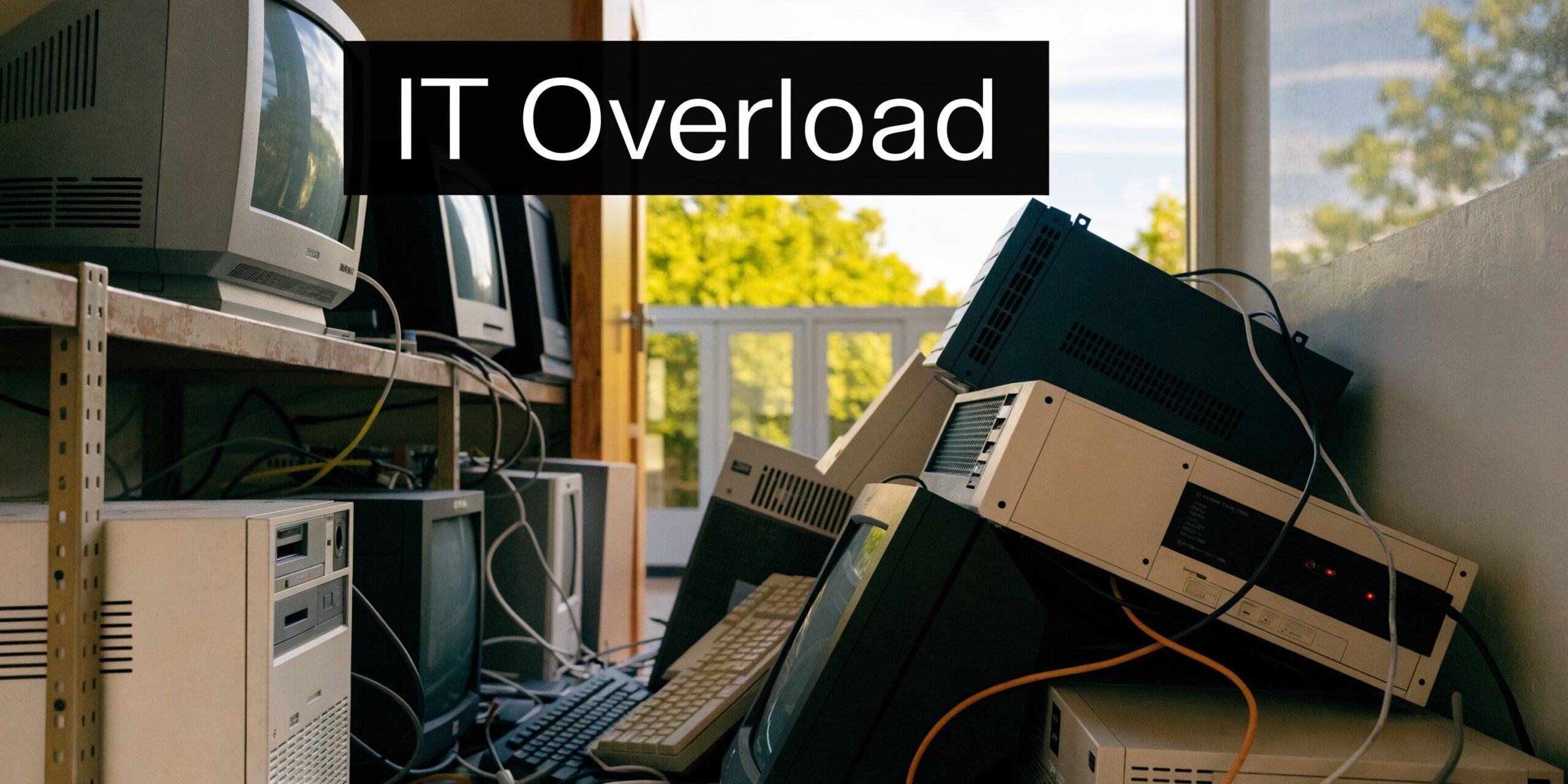 A large pile of outdated computers, monitors, and electronic waste cluttering a room in IT overload.